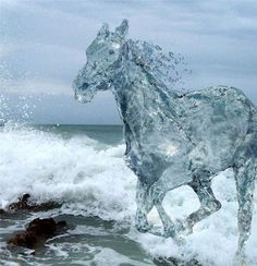 an image of a horse made of water running through ocean waves. a dog is swimming in the water near the horse. the sky is overcast.