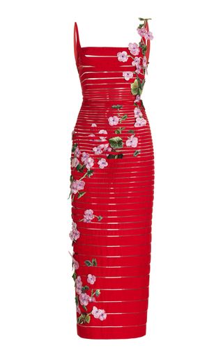 a red midi bodycon dress is adorned with pink flowers and green leaves. the dress has a sleeveless design with a square neckline and features horizontal bands throughout the bodice.