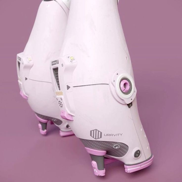 the image shows a pair of futuristiclooking high heels or shoes, with a sleek, white and pink design. the brand "uravity" is visible on the side. the shoes have a unique, technological aesthetic, appearing almost like miniature spacecraft. the background is a solid, light purple color.