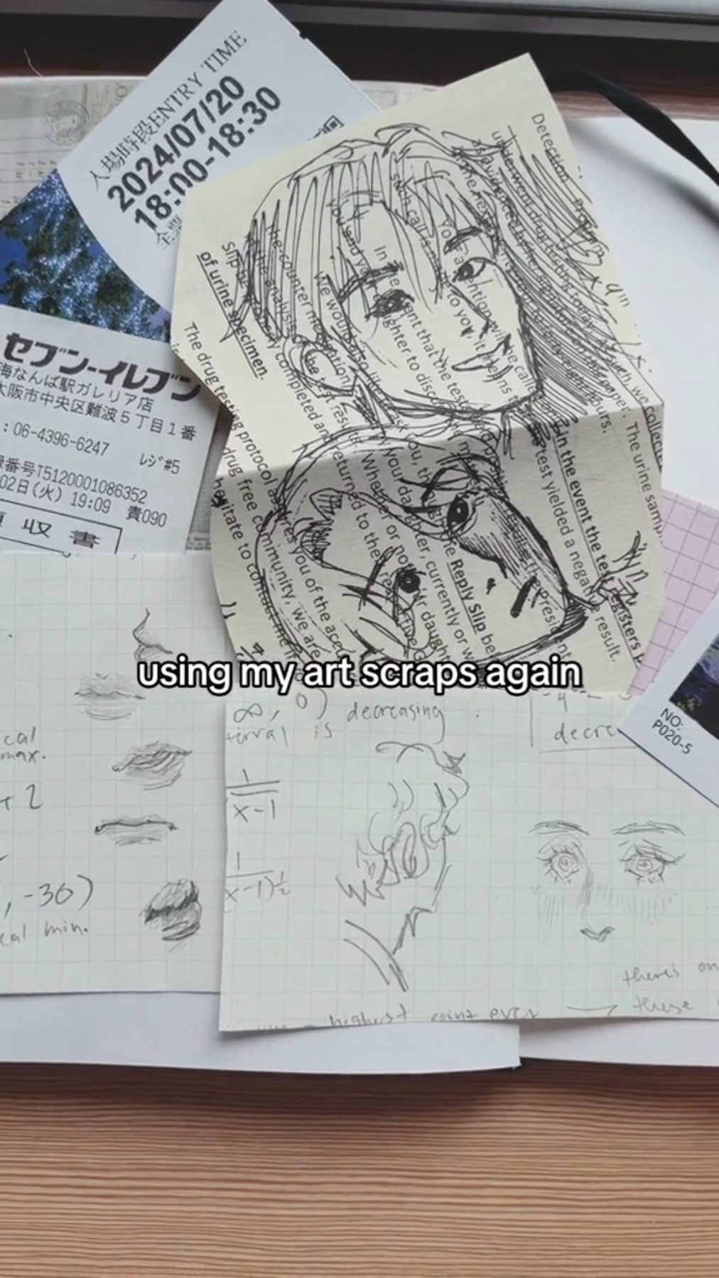 a top down view of a desk with scattered art pieces. the pieces are mainly character sketches and doodles done traditionally on scrap pieces of paper. the pieces seem to be practice, using each other as reference. there's a ticket stub visible under the art pieces.