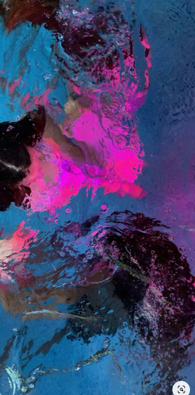 the image is an abstract painting with pink, black, and blue acrylic paint on a canvas. the paint has a fluid texture, as if it were poured or dripped onto the canvas.