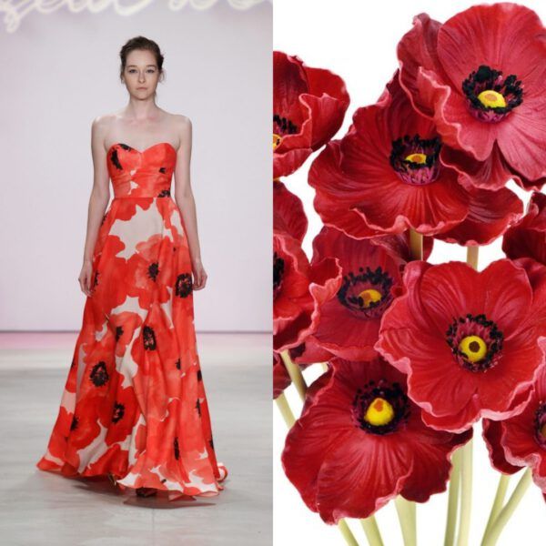 a woman in a red dress with a poppy print stands on a runway. to her right, a bouquet of large red poppies.