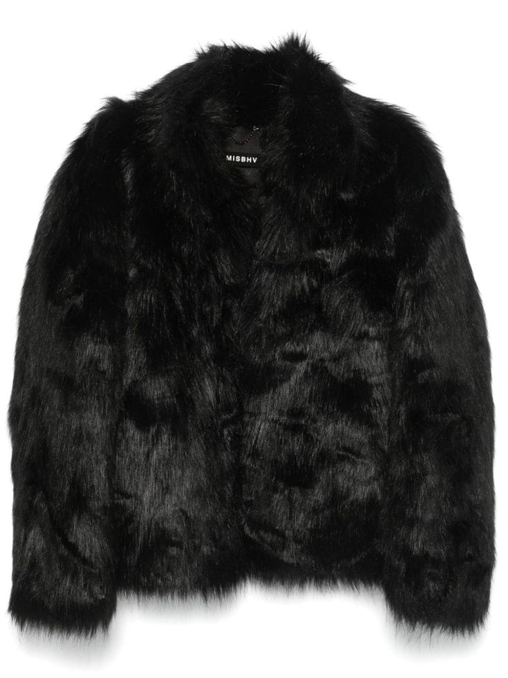 a black faux fur jacket with a fluffy texture and a slightly oversized fit. the jacket has a collar and a button closure. the brand name "missguided" is visible on the inner label.