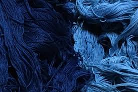 a closeup image featuring a collection of blue yarn in various shades, showcasing the intricate textures and fibers of the material.