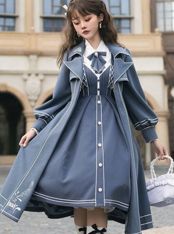 a young woman is posing outdoors in a blue lolita fashion outfit. she is wearing a blue dress with white trim and a matching coat. she is also carrying a white purse. the photo is taken from an eyelevel perspective and the lighting is natural.