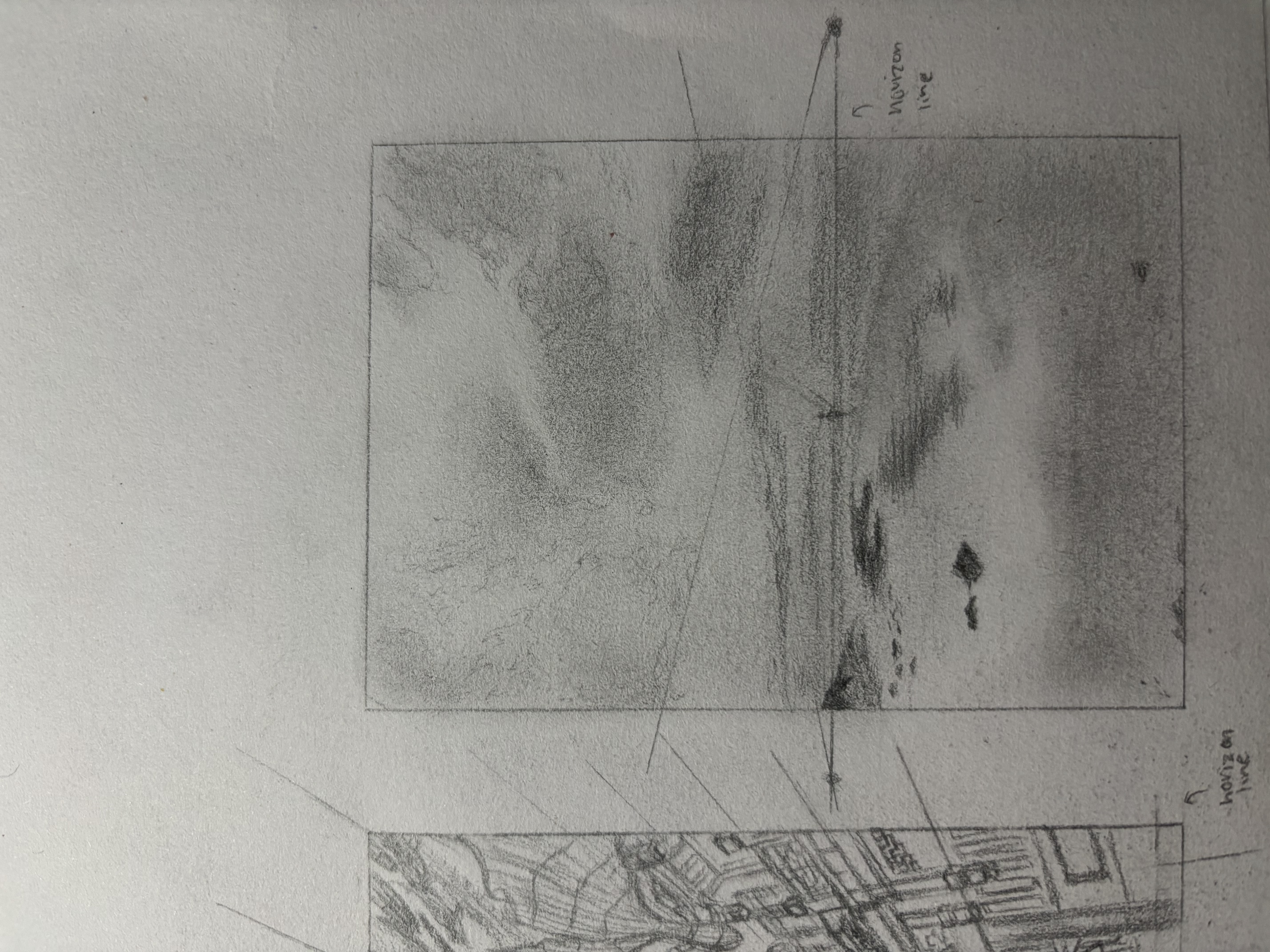 a pencil sketch of a seascape is depicted. the drawing includes a horizon line, cloudy sky, water with reflections, a small figure in the distance, and rocks in the foreground. perspective lines are visible, suggesting a study in composition. the image appears to be a preliminary sketch or thumbnail. another separate drawing of a city is present next to it on the paper, also sketched in pencil.