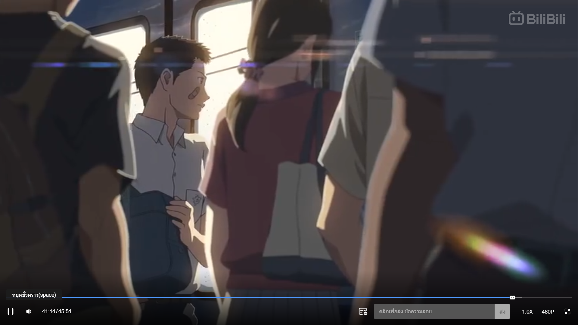 the image is a still from an anime film or series. it depicts a scene inside a moving train, likely in japan. sunlight streams through the windows, creating a bright and warm atmosphere. there's a noticeable lens flare effect. two young people, a man and a woman, are the focal point, seemingly engaged in a conversation. they are surrounded by other commuters, although their faces are obscured. the man has short dark hair and is wearing a white shirt with a dark jacket. the woman has long dark hair and is wearing a red shirt.  the overall palette is warm and inviting, with soft yellows, browns, and whites dominating.
