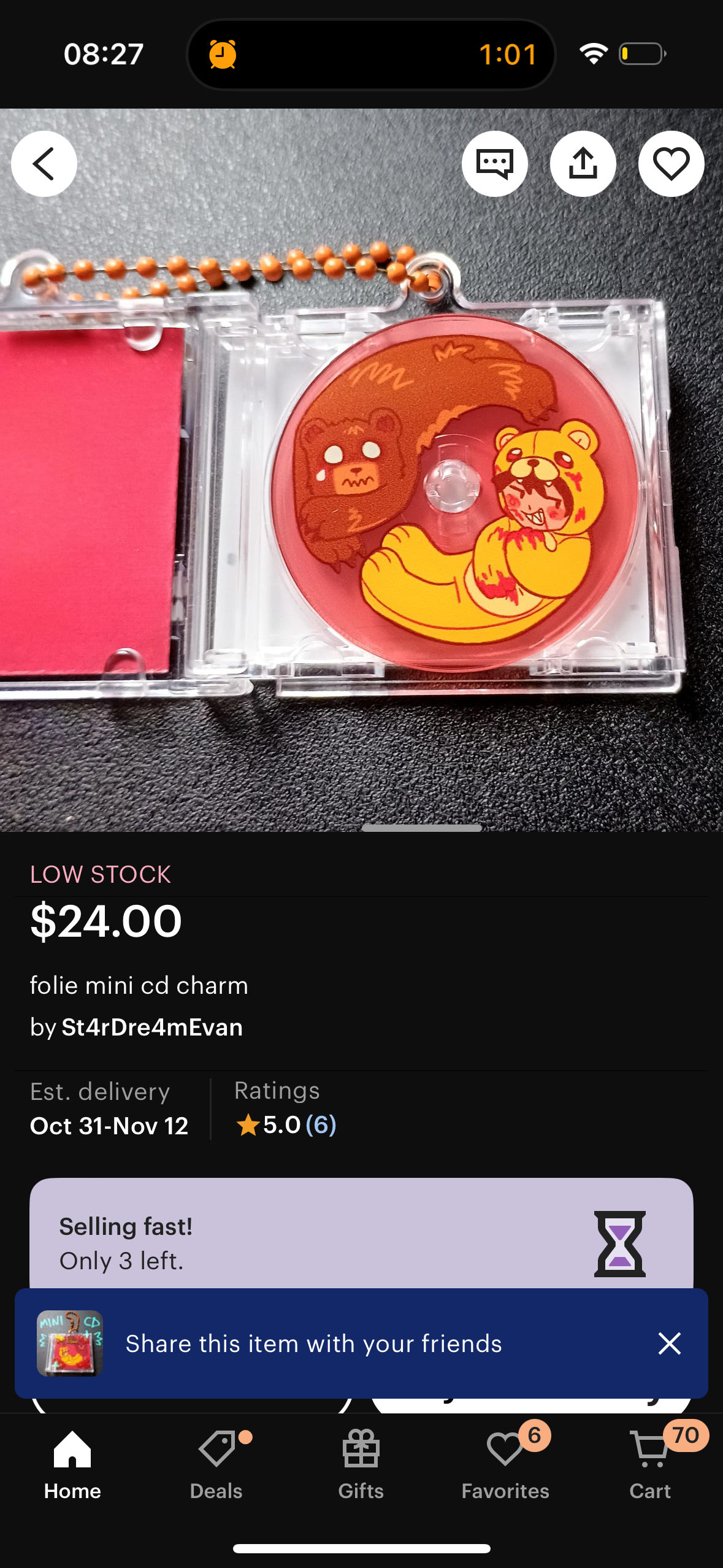 this image shows a product listing for a cd charm that is for sale. the charm features a cute anime style character, and the charm is shaped like a small cd.  the background is black, and the product details are listed above the charm. the charm is listed as being low stock, and is selling fast. the image includes a button to share the item with friends.