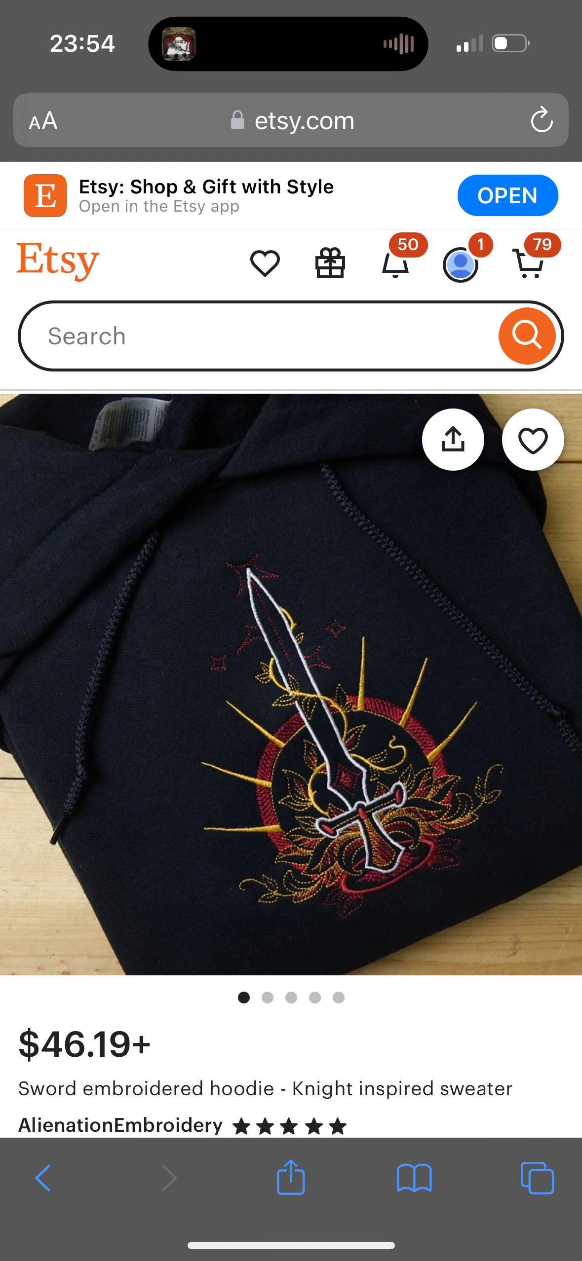 a closeup image of a black embroidered hoodie with a sword design on the front. the embroidery is in gold and red, and the design is inspired by knights. the hoodie is on a white background, and the listing is on etsy. the listing is titled "sword embroidered hoodie  knight inspired sweater" and is sold by "alienation embroidery".  a white bar at the top of the image shows that the user is on the etsy app, the time is 23:54, and the url is "etsy.com". the top of the image is cropped to show the app's search bar. the user is looking at the product in the etsy app.