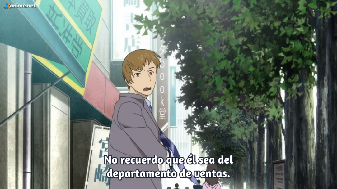 an anime still featuring a young man in a business suit, briefcase in hand, standing on a city sidewalk. he appears confused or bewildered. surrounding him are storefronts and leafy trees lining the street. the color palette leans towards muted greens and grays, suggesting a cloudy day in a bustling urban environment. ```
