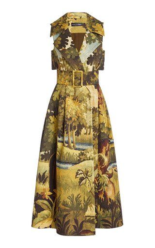 a sleeveless vintageinspired dress with a floral tapestry print. the dress is belted at the waist and has a vneckline. the print features greens, browns, yellows, and golds. the dress is elegant and formal, perfect for a special occasion.