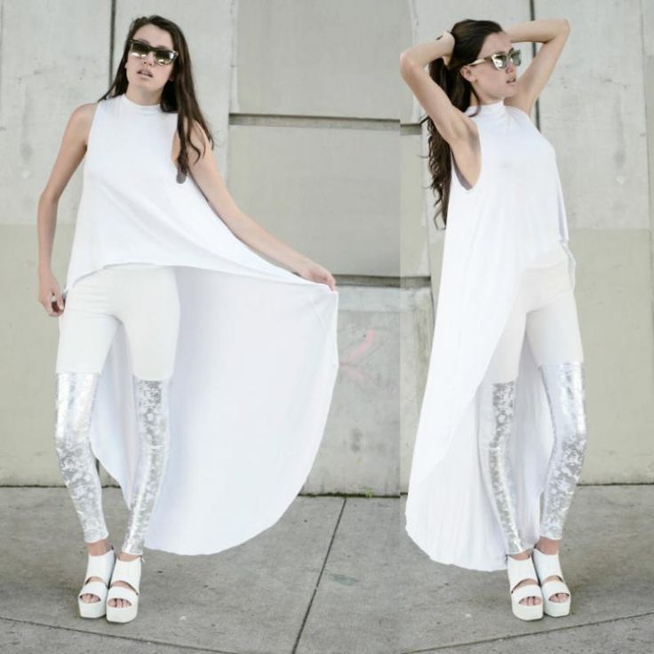 a woman is seen in a splitimage photo, posing in a fashionable outfit. she is wearing sunglasses, a long white sleeveless dress, white pants, and striking silver leggings. her footwear consists of white platform sandals. the background suggests an outdoor urban environment, possibly a street setting. the splitimage duplicates her pose, offering different perspectives of the same outfit. in one shot, she is holding the side of the dress to reveal more of the outfit and in the other she has her arms up behind her head.