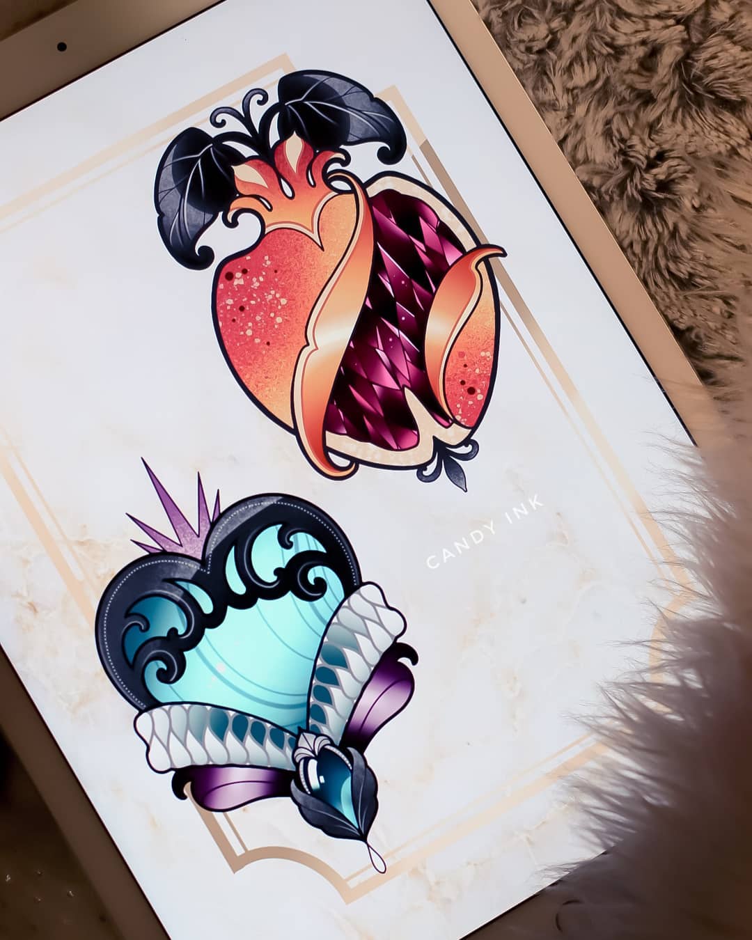 this image shows two tattoo designs displayed on a tablet. the design at the top is a heart shaped like a pomegranate with jewels and gold details. the design at the bottom is a heart with a crown, jewels, and flowing lines, colored in teal, purple, and white.