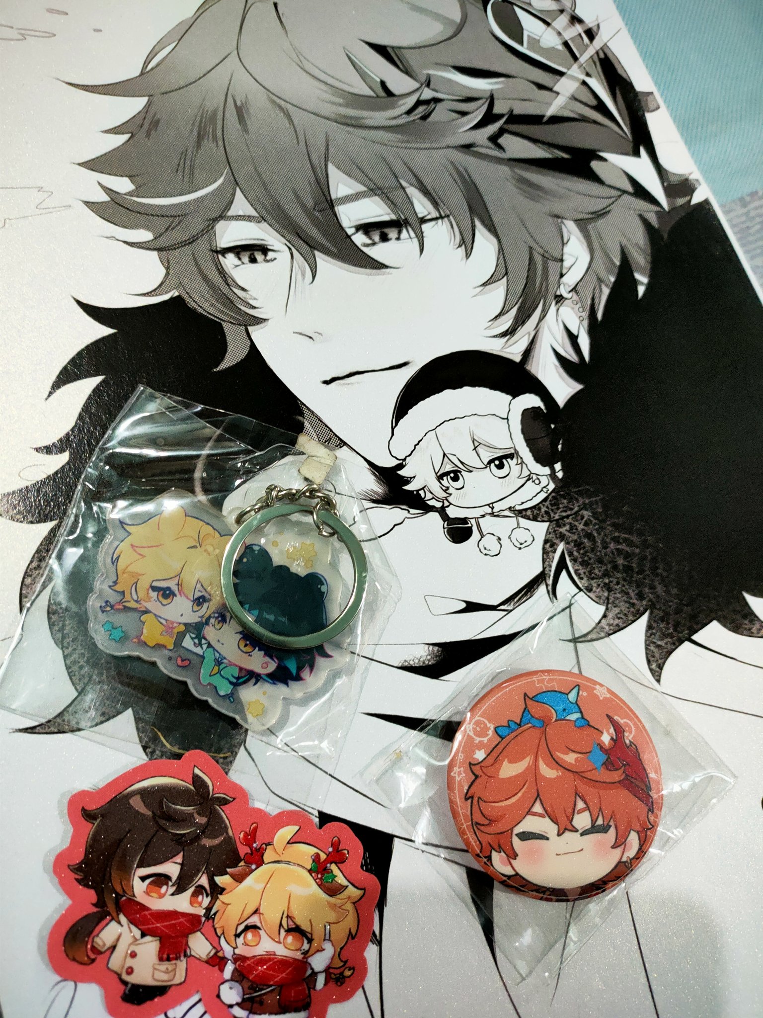the image shows a collection of animerelated merchandise laid out on top of a larger piece of fanart featuring a male anime character with brown hair. the merchandise includes: keychain:  a doublesided acrylic keychain featuring two smaller anime characters, one with blonde hair and another with dark hair, possibly representing a pair of characters. acrylic charms: two separate individual acrylic charms. one is a pair of anime characters, the other a single character.  button badge/pin: a circular button badge showing a chibistyle anime character with bright orange hair. background fanart: a large grayscale illustration of a male anime character with brown/grey hair; he seems to be the central figure in relation to the other smaller character charms.all the items are wrapped in plastic packaging suggesting they are new merchandise or recently acquired collectibles. the overall aesthetic is strongly linked to anime and manga fandom, with the items likely being fanmade or officially licensed products.