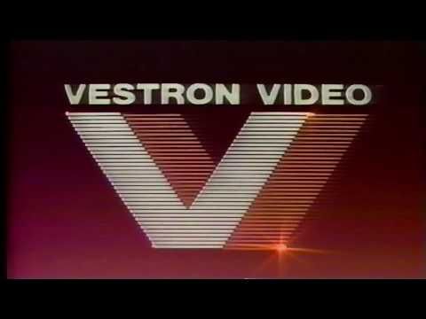 the image showcases the iconic logo of vestron video, a prominent home video distributor in the 1980s and 1990s. the logo features the word "vestron video" in a bold, white sansserif font against a burgundy backdrop. a distinctive stylized "v" with a striped design, resembling a film strip, is positioned beneath the company name. the vibrant red and white color scheme and the striking geometric design create a memorable and visually captivating logo that epitomizes the aesthetic of the 80s video era. the image evokes nostalgia for classic films and the golden age of home video.