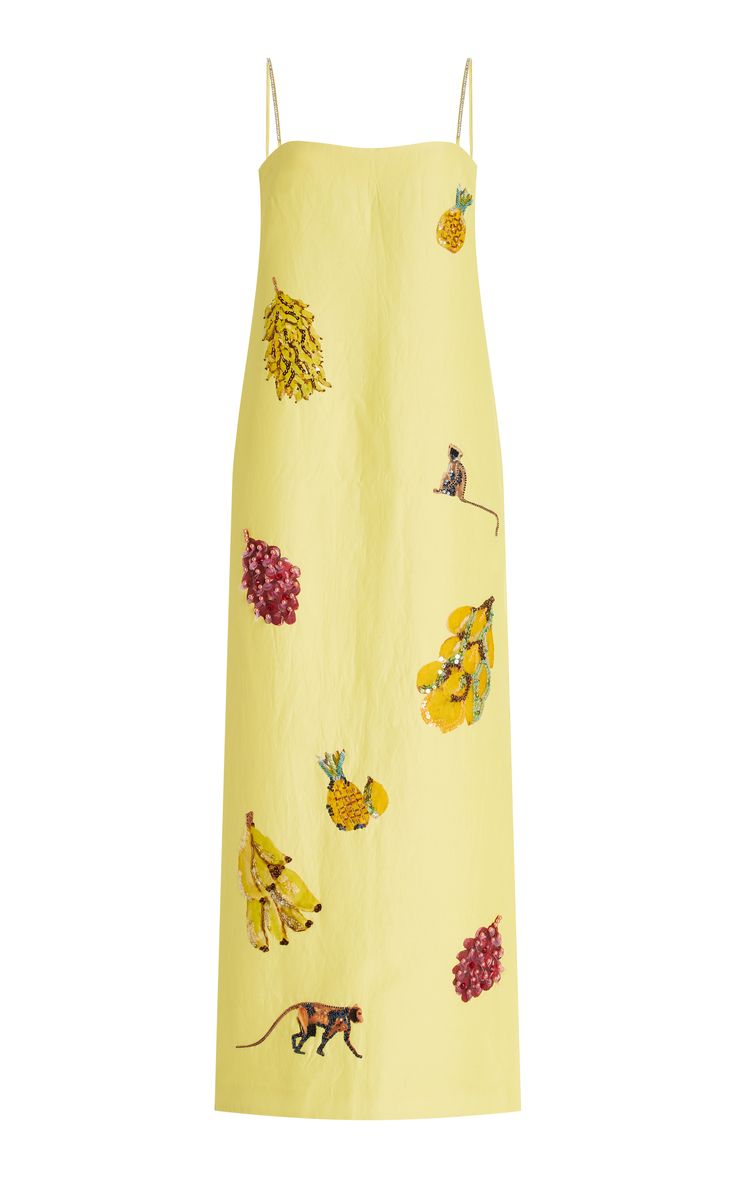 a yellow maxi dress with a floral print, featuring fruits like pineapples, bananas, and grapes. the dress has a sleeveless design and is perfect for summer.