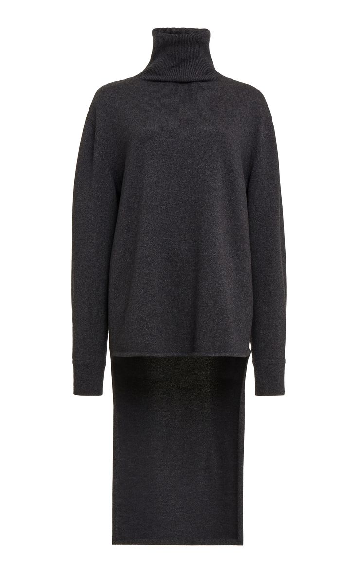 a grey highlow turtleneck sweater with long sleeves and a relaxed fit. the sweater is styled with a slightly oversized fit and features a high turtleneck and a longer back hem. the sweater is made from a soft, comfortable fabric and is perfect for casual wear.  it's chic and stylish.