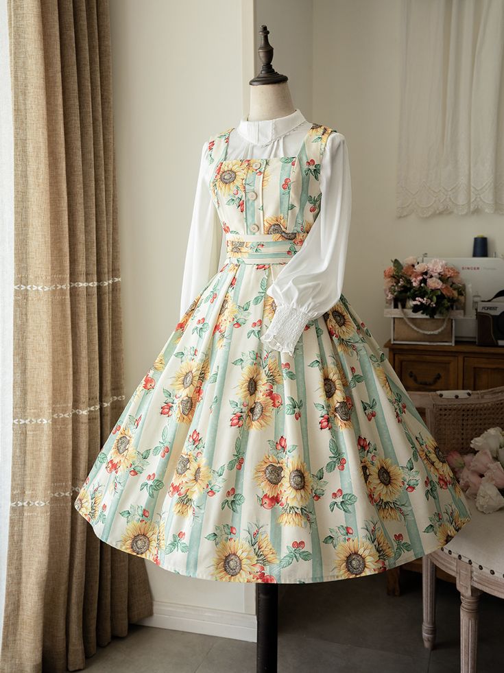 a sunflowerpatterned dress is displayed on a mannequin in a welllit room. the dress features a vintageinspired design with a fitted bodice and a full skirt. the sunflowers are a prominent feature of the pattern, adding a touch of cheerfulness to the overall look.