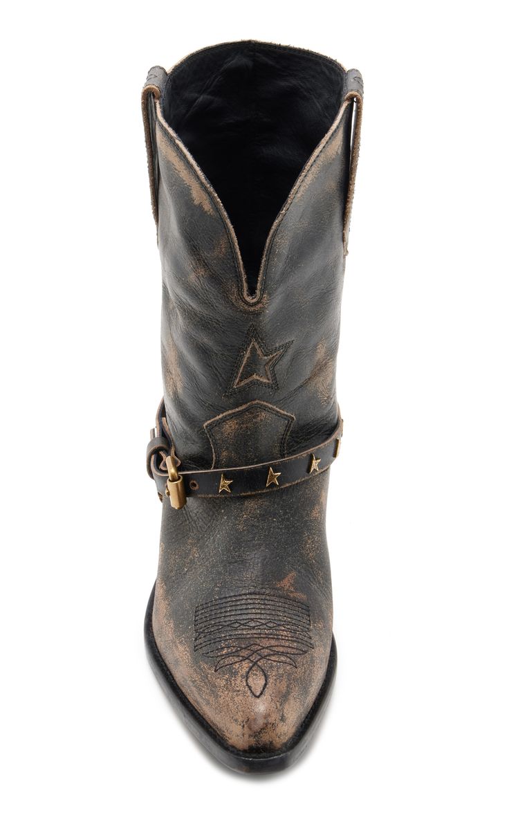 a topdown view of a pair of women's distressed leather cowboy boots. the boots are brown and black with a star design on the shaft and an ankle strap with a buckle. the boots appear to be vintage or have a vintageinspired design.  the leather shows signs of wear and discoloration, adding to the distressed look. the inside of the boots is visible, showing dark brown or black leather.