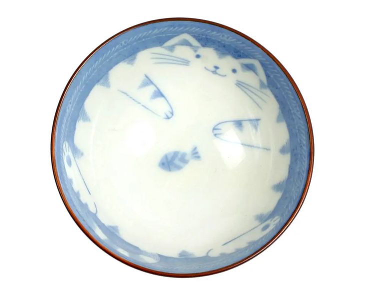 a ceramic bowl featuring a cat and fish design is viewed from above. the bowl has a white interior with a light blue cat cartoon design in the center with a fish. the bowl also has a brown rim.