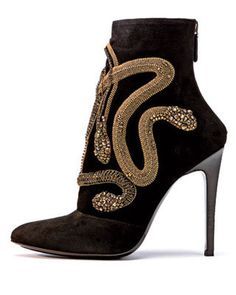 the image shows a pair of women's black suede ankle boots with a stiletto heel. the boots are embellished with a gold snake design made of beads and metallic accents. the snake design wraps around the side and back of the boot. the boots are shown on a white background.