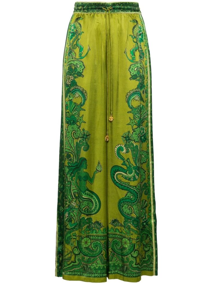 a pair of green women's pants with a floral print. the pants are wide legged and made of silk. they have an elastic waist and are high waisted. the pants are a bohemian style and are vintage inspired. they are perfect for a summer day or a special occasion.
