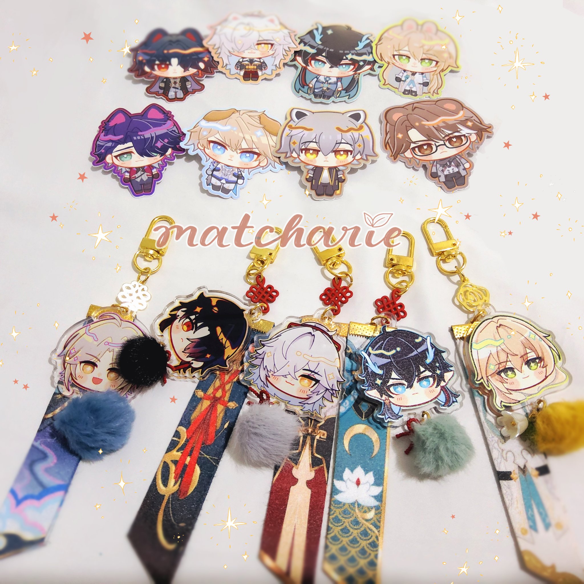 this image showcases a collection of adorable animestyle keychains.  each keychain features a chibi character with big eyes and a charming expression,  set against a colorful background. the characters are dressed in various outfits and have different accessories. the keychains are attached to gold chains with decorative charms,  and the image appears to be taken on a white background with sparkly stars.  the word "matcharie"  is written in  a stylized  font at the top of the image.  these keychains  are  perfect  for  fans  of anime,  manga, or  simply those who enjoy  cute and collectible accessories.