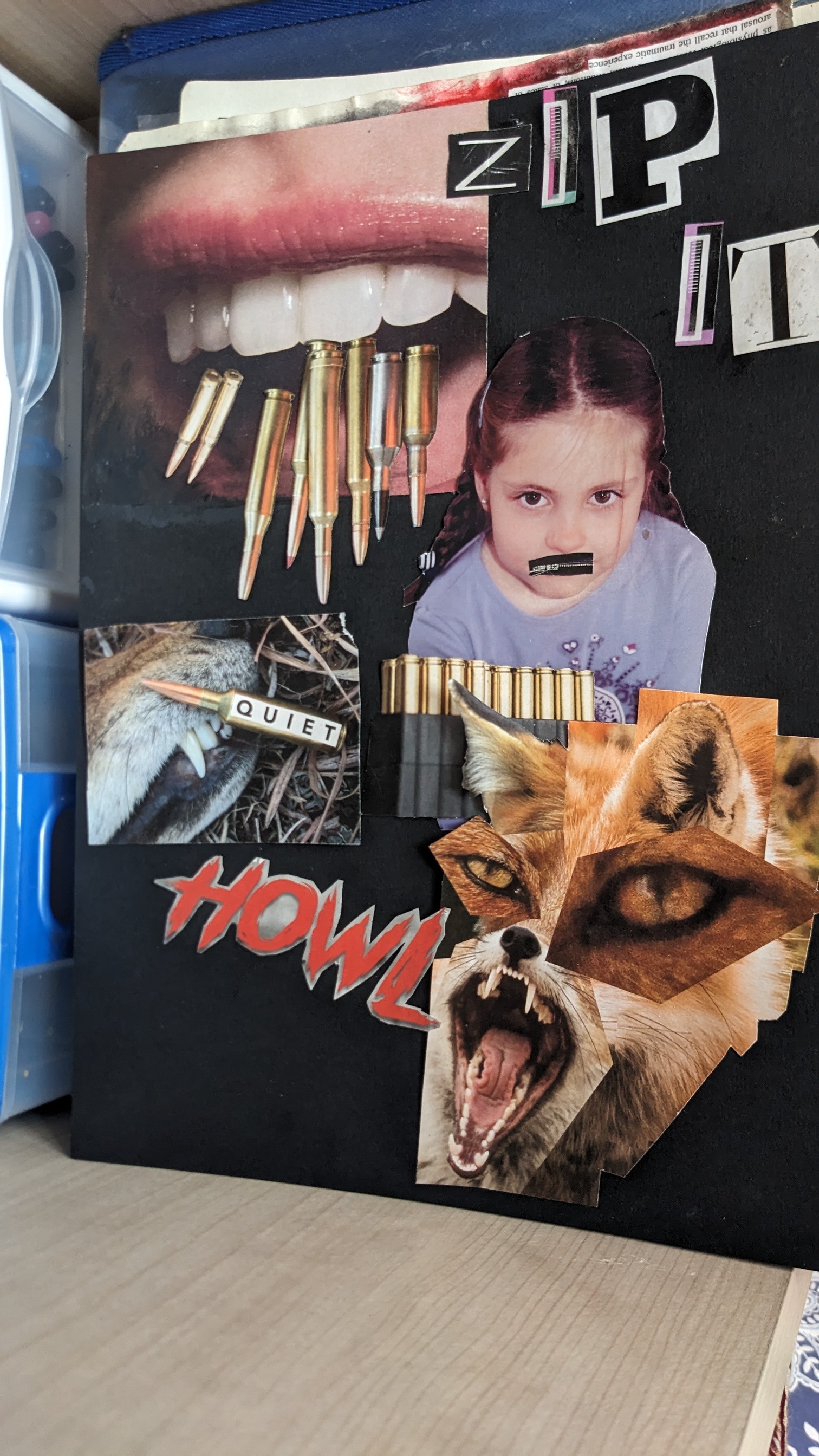 collage artwork is displayed, featuring a stark contrast between a child's face and violent imagery.  the central figure is a young girl with a piece of black tape over her mouth. surrounding her are images of a mouth filled with bullets, a fox's snarling face, and text fragments such as "zip it" and "howl." the overall effect is jarring and thoughtprovoking. the piece is assembled on a black background with other printed materials and various textures.  a small image depicts a paw holding a bullet labeled "quiet". the style suggests a commentary on silencing and violence.