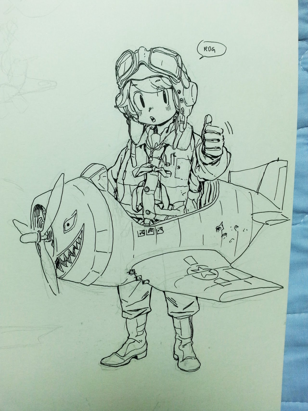 a black and white line drawing of a cartoon character, a pilot, with a big smile. the pilot is sitting in a small cartoon plane, with a star on the side. the plane has a toothy snout. the pilot is wearing a flight helmet and goggles and a jacket with a zipper.  there is a speech bubble above the pilot's head that says "rog."  the pilot is giving a thumbs up and looks excited to fly. the character looks very animated and fun.