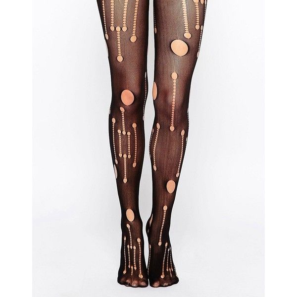 the image shows a pair of legs wearing black tights with a pattern of polka dots and vertical lines. the tights appear to be sheer or semisheer. the background is white.