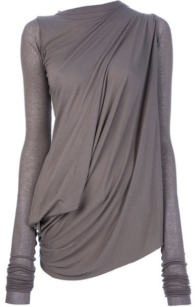a closeup of a grey draped longsleeved shirt with an asymmetric hem. the shirt is loosefitting and casual, with a draping effect that creates a unique and stylish silhouette.  the shirt is a great example of how to wear draping in a modern and edgy way.