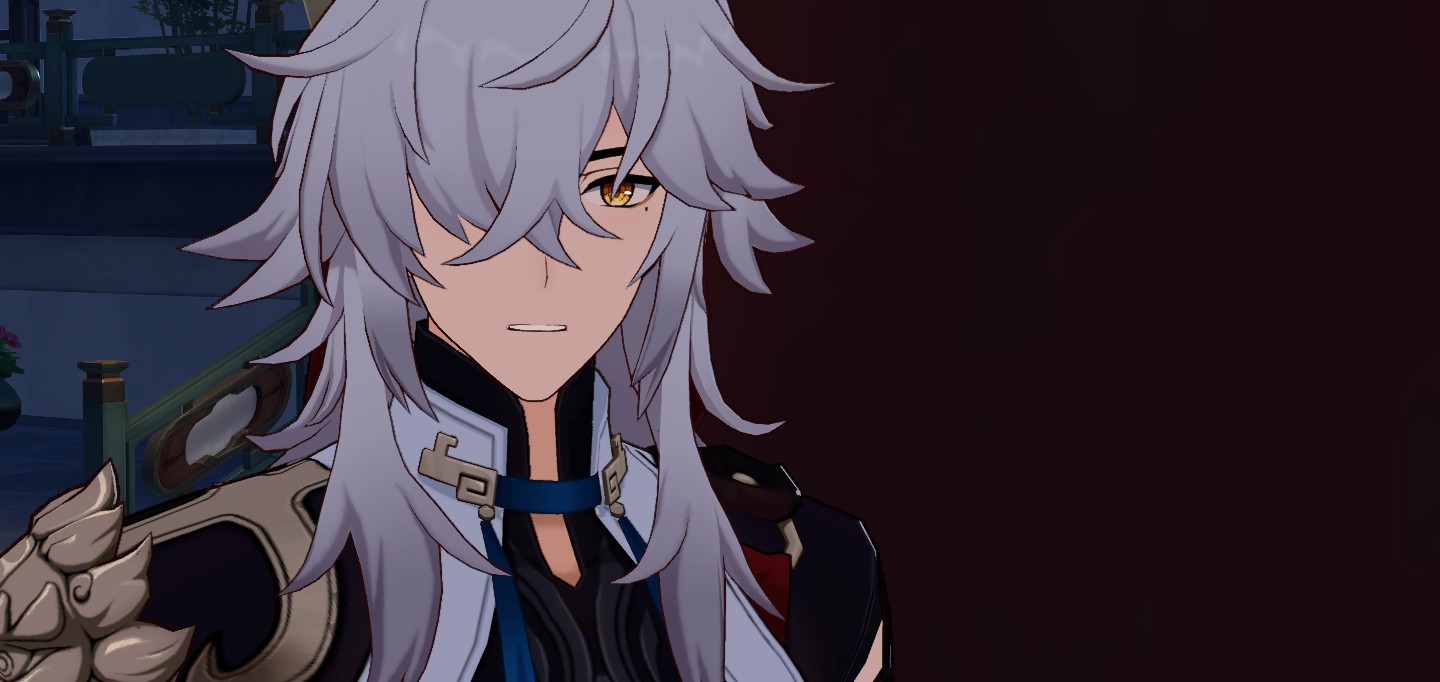 a closeup image of a male anime character with white hair, yellow eyes, and a serious expression. he is wearing a black shirt, blue necklace, and a white jacket. the background is dark.