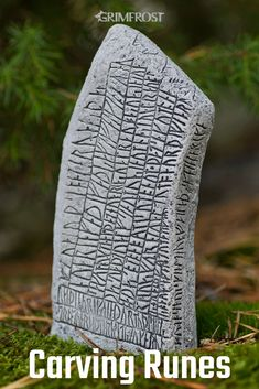 the image shows a runestone with carved inscriptions, likely runes, set against a backdrop of moss and greenery. the stone is gray with dark carvings. the word "grimfrost" is visible in the upper portion of the image. the text "carving runes" is at the bottom.