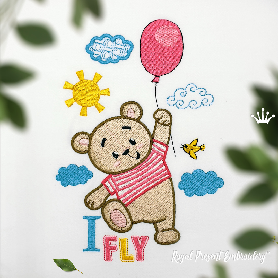 a cute teddy bear is holding on to a red balloon and flying in the sky, surrounded by clouds, a sun, and a bird. "i fly" is written below the bear. this is a digital embroidery design, perfect for crafting clothing, towels, and other items for babies and children.