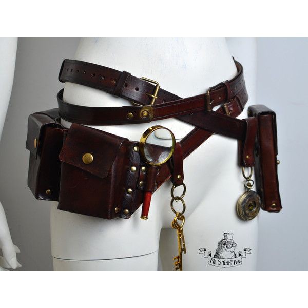 a brown leather steampunk belt is displayed on a mannequin, featuring pouches, a magnifying glass, a key, and a pocket watch. the belt is adorned with brass details.