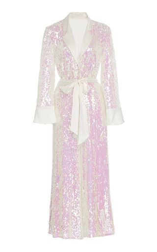 a long, pale pink and white sequin robe with a white belt.