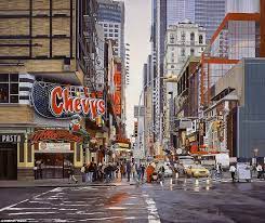 the image shows a busy street in new york city. the street is lined with tall buildings, including skyscrapers. there is traffic on the street, and many people are walking on the sidewalk. the image is captured from the street level. there are many neon signs, and the street is full of energy and activity.