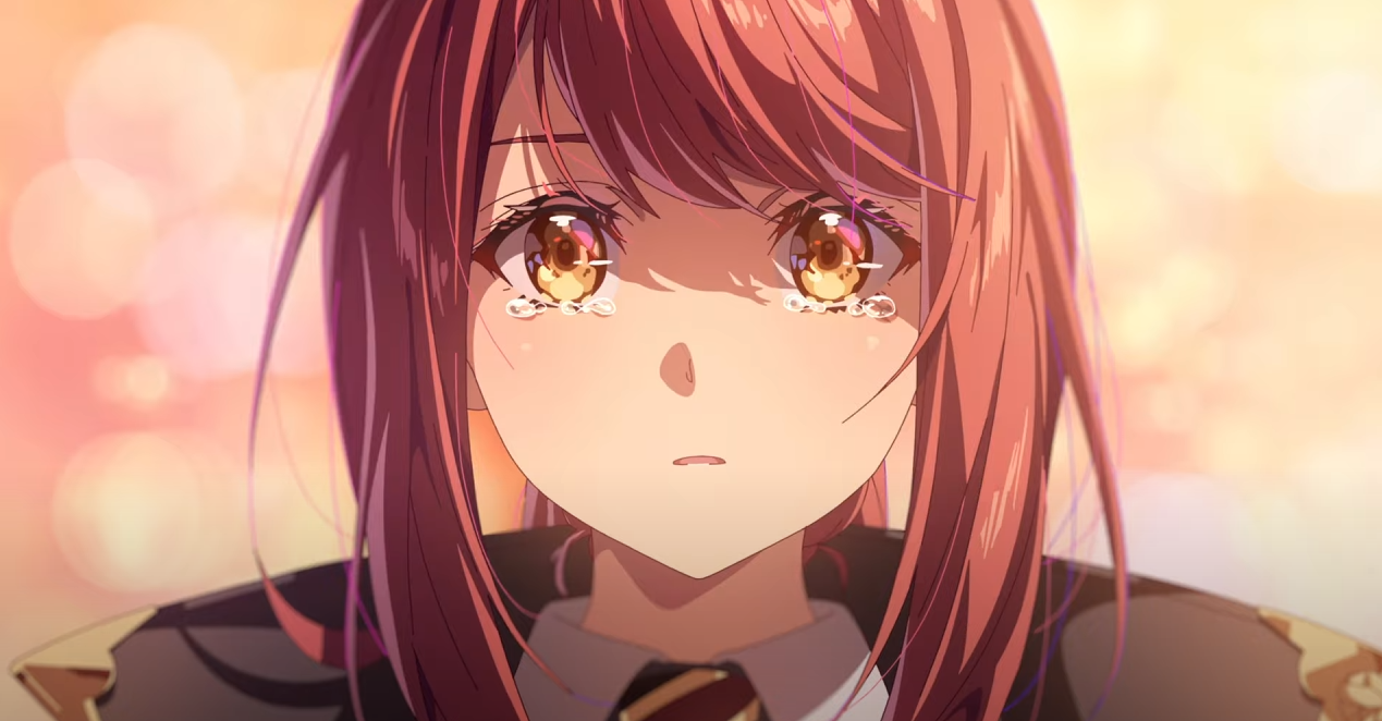 loseup view of an anime girl with long, reddishbrown hair and large, golden eyes.  tears are streaming down her face, and her expression is one of sadness and distress. the background is a soft, blurry orange and pink, suggesting a sunset or sunrise.  she appears to be wearing a darkcolored uniform with gold accents. the overall mood is melancholic and emotional.