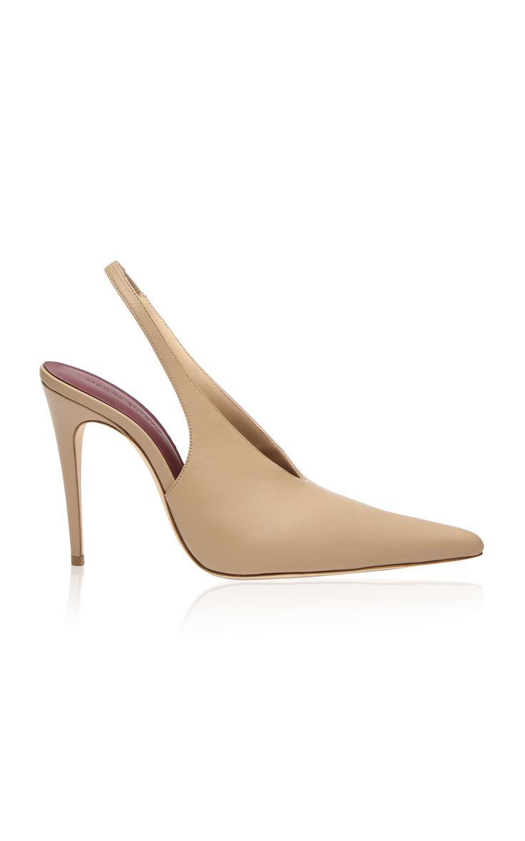 a pair of beige leather slingback pumps with pointed toes and stiletto heels.  the shoes are photographed against a white background.