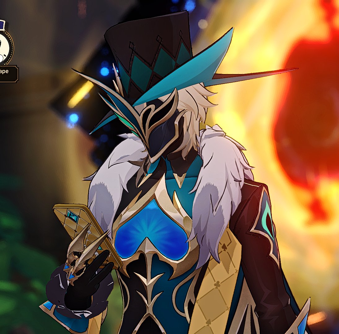 a character from the popular video game "genshin impact", scaramouche, is shown in a closeup portrait.  he's wearing a stylish outfit with a large blue hat adorned with a mask and gold accents. the character is holding a large glowing blue playing card. the background is blurred and includes a fiery orange orb.