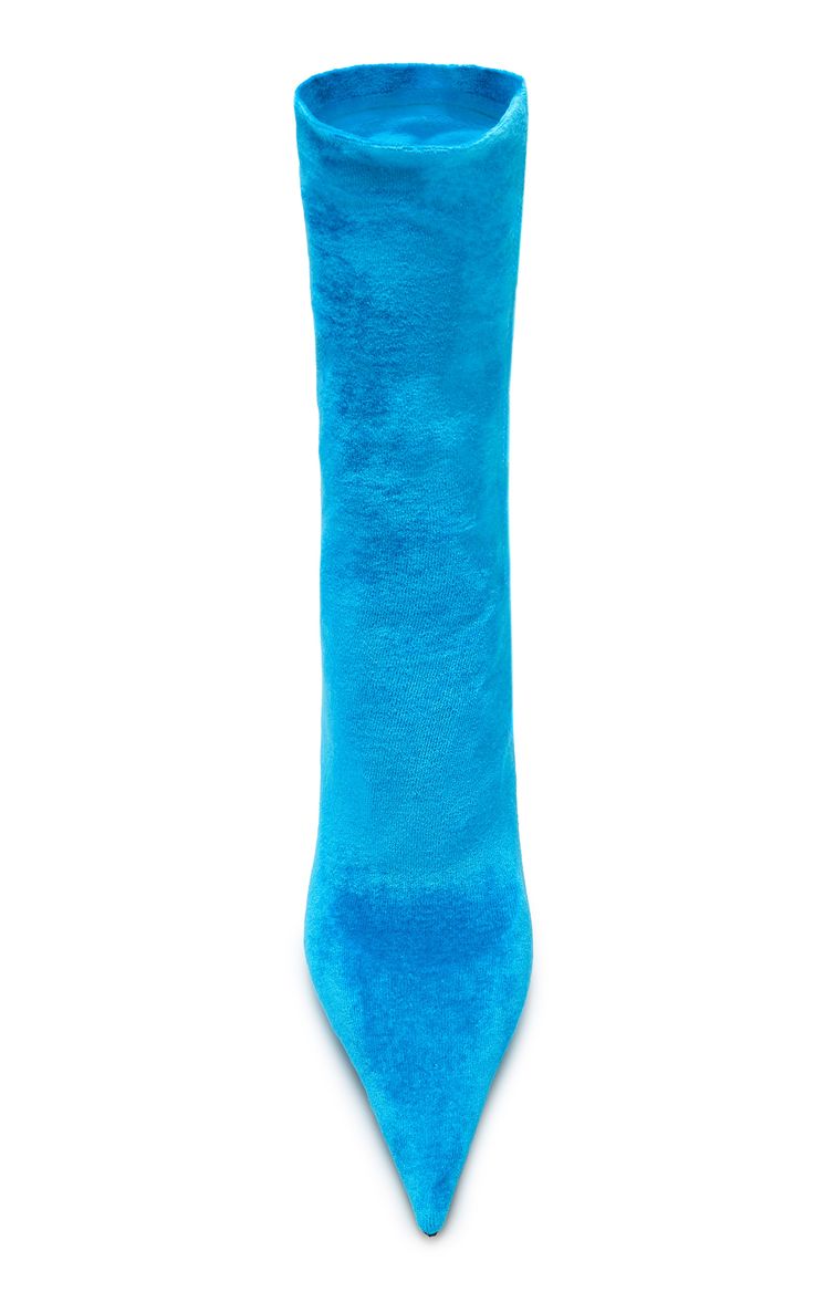 a closeup, topdown shot of a single women's bright blue velvet pointedtoe ankle boot against a white background. the boot is a midcalf height with a sleek, pointed toe and appears to be made of a soft, plush velvet material. the color is a vibrant, eyecatching shade of blue. the image is welllit and showcases the texture and shape of the boot.