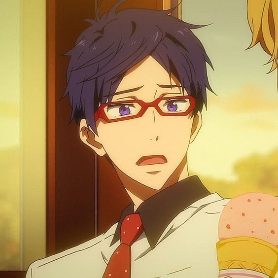 the image shows a young man with short blue hair and red glasses. his expression is one of surprise or confusion, with his mouth slightly open and his eyebrows raised. he is wearing a white shirt with a black collar and a red tie with white polka dots. the background is a warm yellow tone.