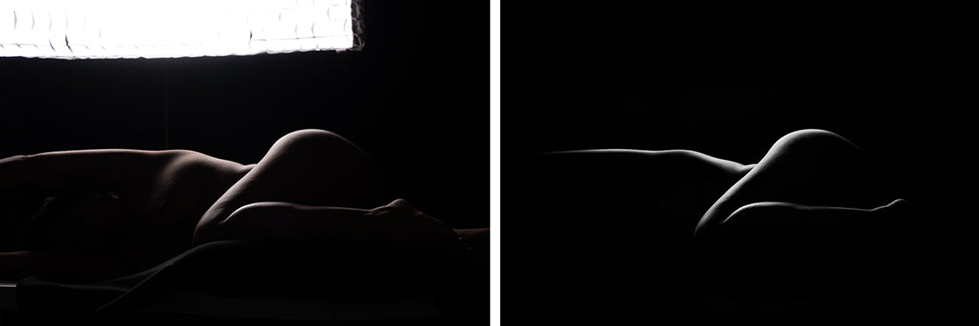 the image is a diptych showing two nearly identical  black and white photographs. both pictures feature a female nude lying down, depicted solely as a silhouette against a dark background. the left image has a brighter background illuminated by what seems to be a softbox, and more definition of the body's curves. the right image is almost entirely in shadow, creating a stronger, more dramatic silhouette with softer edges. both images showcase the subject's form through contrast and subtle highlighting of the body's contours.  the overall effect is artistic and evocative, focusing on shape and form rather than explicit detail.