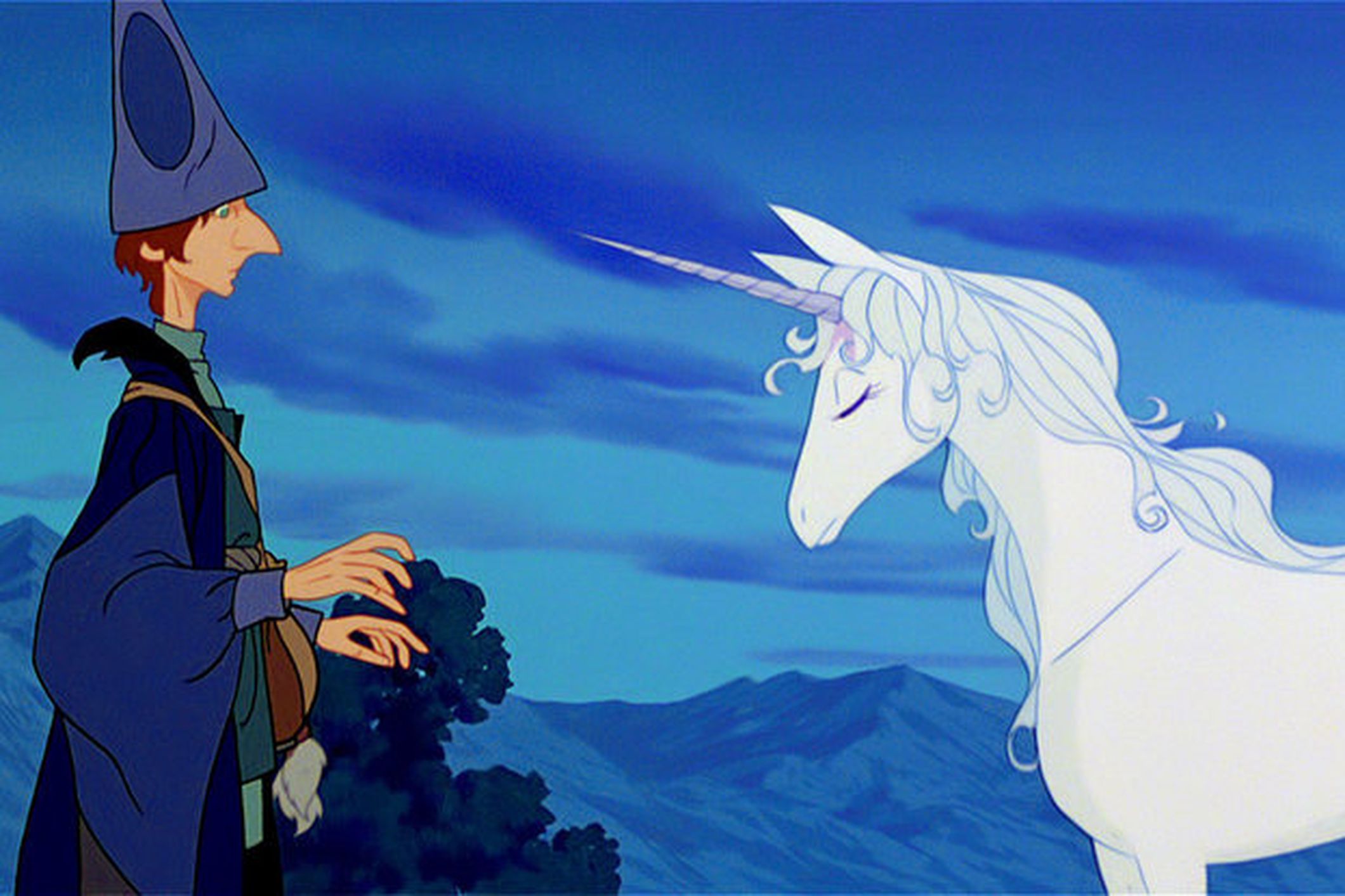 this is a scene from the animated film "the last unicorn", featuring a white unicorn standing in a lush forest. it has a magical and whimsical feel with beautiful blue clouds and a distant man wearing a hat and robe standing in the foreground.