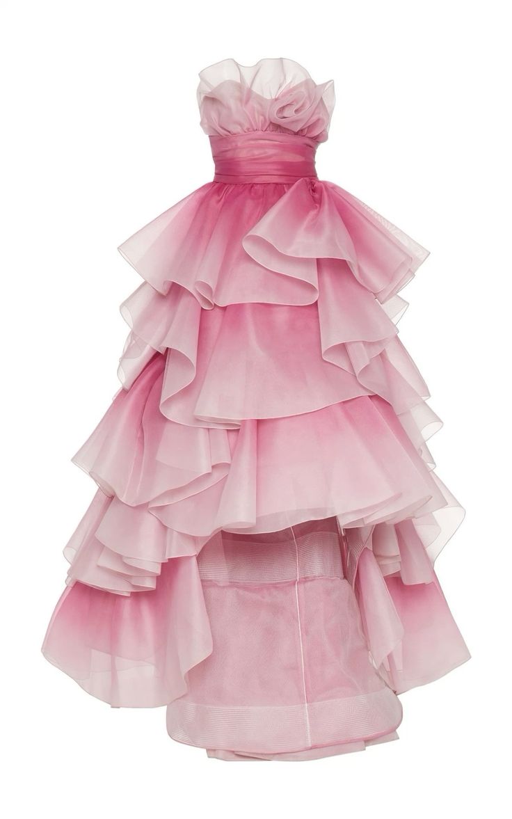 a pink strapless gown with a highlow hem. the dress is made of layers of tulle and has a ruffled design. it is a formal dress that would be perfect for a special occasion. the dress is in the style of the 1980s, with an ombre pink design from a darker pink to a lighter pink.