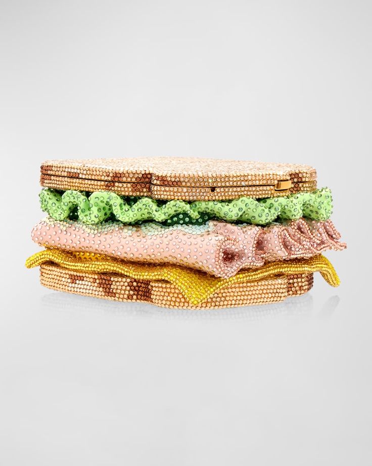 a sparkly, crystalencrusted sandwich purse with a green lettuce, pink meat, and yellow cheese filling. this unique and whimsical accessory is sure to turn heads and add a touch of fun to any outfit.