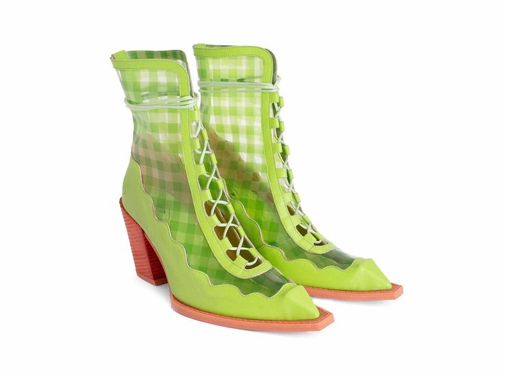 a pair of green and clear heeled boots with a square toe on a white background. the boots have a clear outer layer with a green and white gingham pattern around the ankle. the laces are white and run up the front of the boot. the heel is a stacked block heel and appears to be salmoncolored. the sole of the shoe is also salmoncolored. the vamp and heel area is lime green.