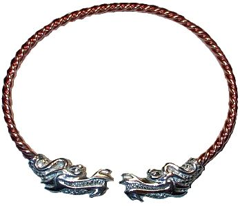 an image of a twisted coppercolored metal bracelet with decorative silver dragon heads at each end. the bracelet is open, forming a cuff style. the dragon heads are detailed and face each other.