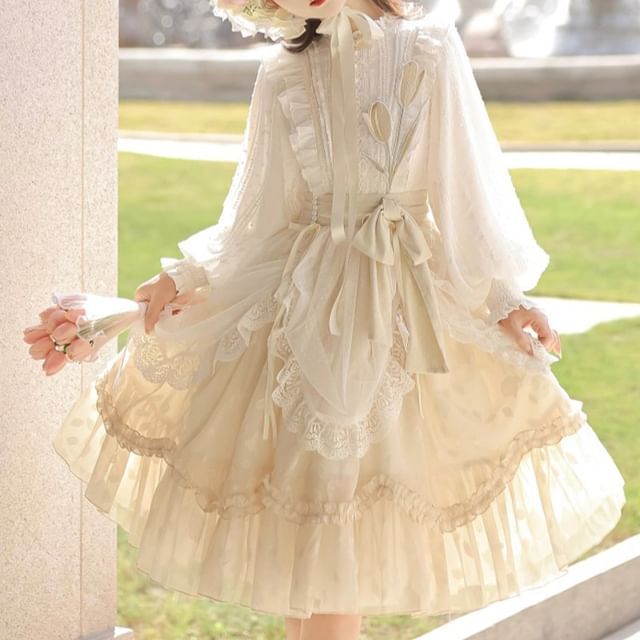 a young woman is wearing a flowing, creamcolored lolita fashion dress. the dress features intricate lace detailing, delicate ruffles, and a romantic, vintageinspired aesthetic. the woman is standing outdoors in bright, natural light.