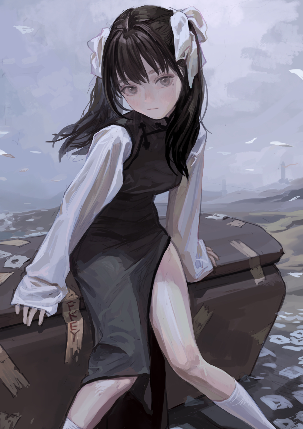 an anime girl with black hair tied with white ribbons, grey eyes, and wearing a longsleeve white shirt and a black dress with a leg slit, sits on a trunk in a landscape with a tower in the background. she is wearing white socks.